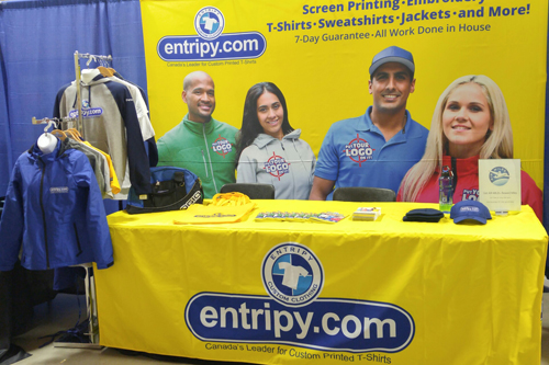 Employees wearing red custom aprons with their logo for a retail company.
