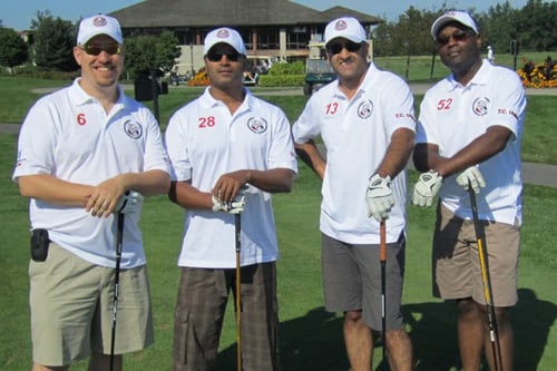 Male and female accessorized with custom hats, embroidered golf shirts and carrying custom promo products such as golf bags and golf clubs.